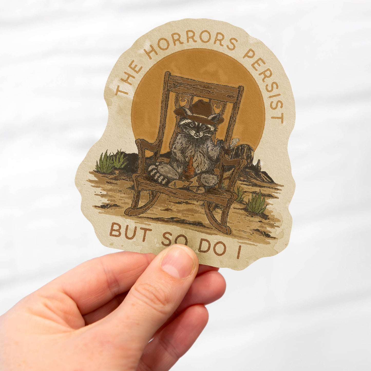 The Horrors Persist But So Do I Raccoon Cowboy Sticker