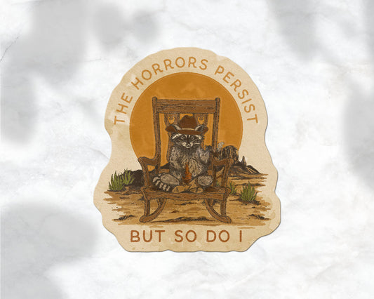 The Horrors Persist But So Do I Raccoon Cowboy Sticker